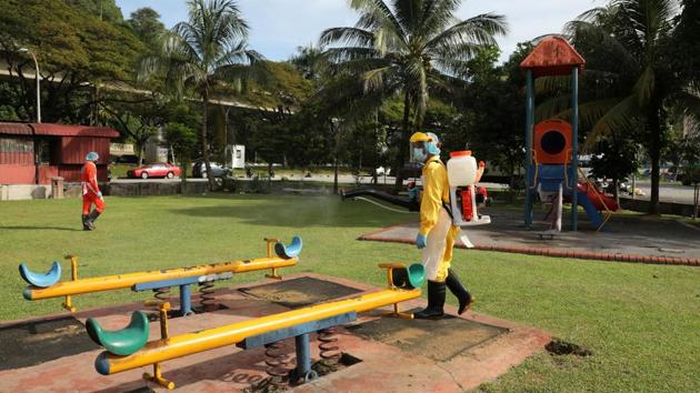 A worker sprays disinfectant at a playground in Kuala Lumpur, Malaysia on October 24. Mike Ryan, head of the World Health Organization’s emergencies programme said on October 19 that Europe and North America should follow the example of Asian states in persevering with anti Covid-19 measures and quarantine restrictions for infected people. (Lim Huey Teng / REUTERS)