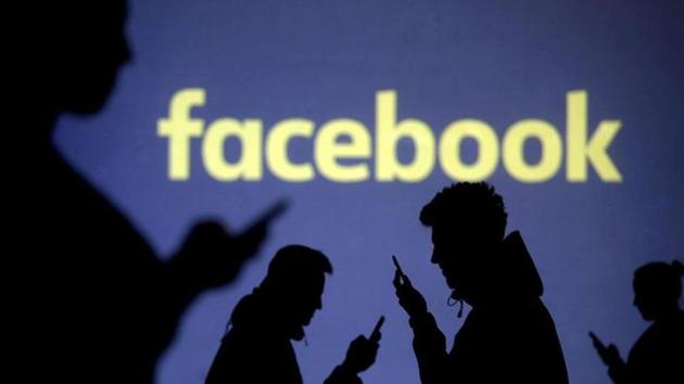 Silhouettes of mobile users are seen next to a screen projection of Facebook logo. (Reuters File Photo) Silhouettes of mobile users are seen next to a screen projection of Facebook logo. (Reuters File Photo)
