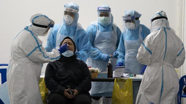 Health ministry workers screen a resident for Covid-19 in Bandar Utama, Malaysia on October 22. Behind only Latin America, Asia now accounts for about one-fourth of the global caseload from the virus. With over 163,000 deaths, the region accounts for some 14% of the global Covid-19 toll as of October 24. (Vincent Thian / AP)