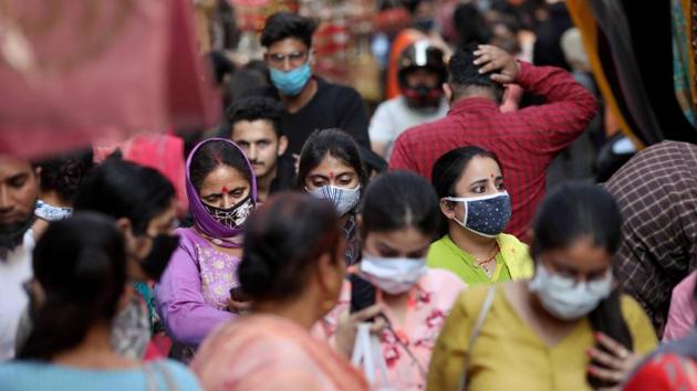 Women wearing face masks as a precautionary measure against the coronavirus visit the crowded Patel Bazar bangles market, in Jammu, on Friday. (PTI) Women wearing face masks as a precautionary measure against the coronavirus visit the crowded Patel Bazar bangles market, in Jammu, on Friday. (PTI)