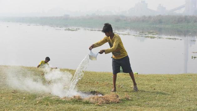 A boy pours water over a burning pile of garbage at Yamuna bank in New Delhi on October 24. Chief minister Arvind Kejriwal, earlier this month, had announced the tree transplantation policy, aimed at increasing the green cover and keeping better checks on construction agencies. (Raj K Raj / HT Photo) A boy pours water over a burning pile of garbage at Yamuna bank in New Delhi on October 24. Chief minister Arvind Kejriwal, earlier this month, had announced the tree transplantation policy, aimed at increasing the green cover and keeping better checks on construction agencies. (Raj K Raj / HT Photo)