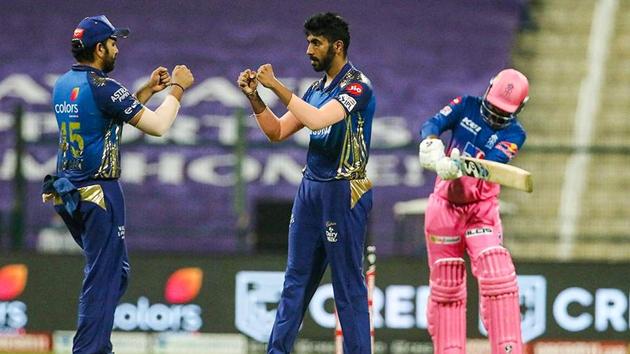 Mumbai Indians skipper Rohit Sharma and player Jasprit Bumrah celebrate the wicket of Rajasthan Royals player Rahul Tewatia during IPL 2020 cricket match, at Sheikh Zayed Stadium in Abu Dhabi.(PTI)