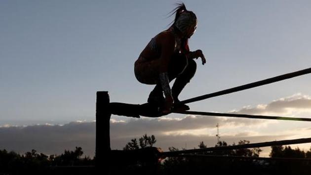 Hades, a female Lucha Libre wrestler, takes part in the first drive-in wrestling event, amid the coronavirus disease (Covid-19) pandemic in Mexico City, Mexico.(REUTERS) Hades, a female Lucha Libre wrestler, takes part in the first drive-in wrestling event, amid the coronavirus disease (Covid-19) pandemic in Mexico City, Mexico.(REUTERS)
