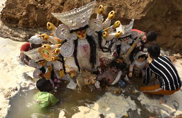 The idol of Goddess Durga being immersed in an immersion pit in the nation’s capital on Monday, October 26. (Praveen Kumar/HT Photos)