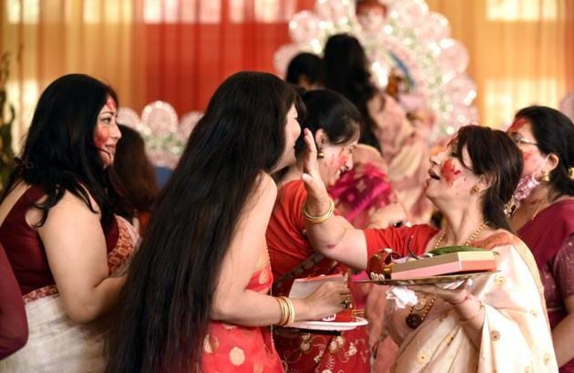 Married women celebrate and worship the Goddess Durga by applying sindoor on each other. (Praveen Kumar/HT Photos)