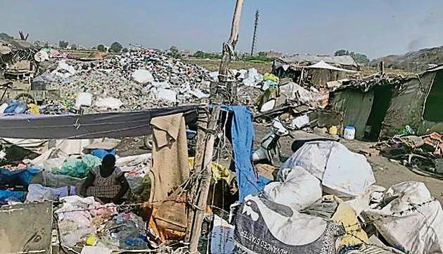 Hosiery waste dumped in streets and open plots at Tibba road and adjoining areas in Ludhiana on Monday.(HT Photo)