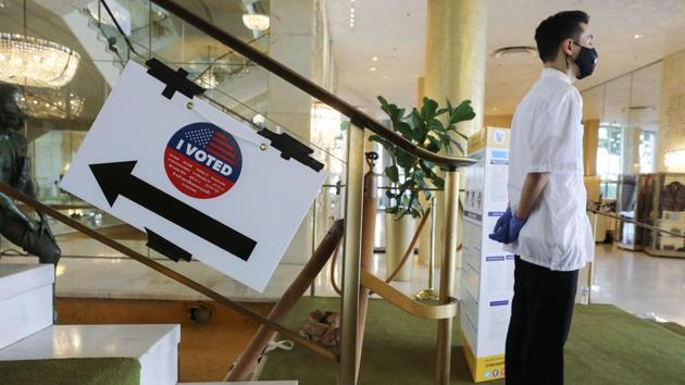 A sign directs voters to the vote centre at the Dorothy Chandler Pavilion in Los Angeles on October 25. So far, Democrats--who have encouraged early voting--have been leading the way. (Mario Tama / Getty Images / AFP )