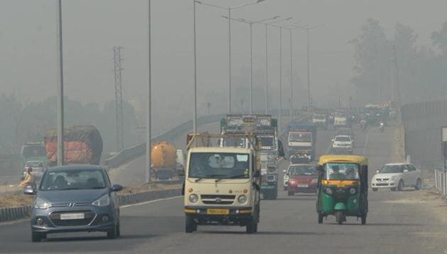 Vehicles ply on Jalandhar-New Delhi National Highway, amid hazy weather conditions, on October 24. (PTI) Vehicles ply on Jalandhar-New Delhi National Highway, amid hazy weather conditions, on October 24. (PTI)