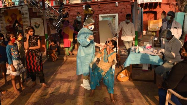 A girl reacts to a health worker taking a swab sample at Kilkari Rainbow Home for Girls in New Delhi on October 25. The health ministry in a statement on October 27 said that the aim for the country now is to achieve a CFR of less than 1% and then sustain it at that level. (Vipin Kumar / HT Photo)