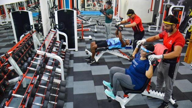 People exercise in a gym after they were allowed to reopen under latest unlock guidelines, in Thane on October 26. The health ministry has attributed these declines to “ramped up medical infrastructure, effective clinical management based on a Standard Treatment Protocol, skill enhancement of ICU doctors and use of non-invasive oxygen.” (PTI)