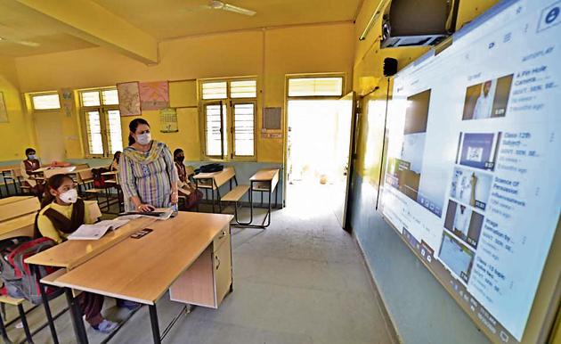 Students of Government Senior Secondary School, Ayali Khurd village attending smart class as school reopens after hiatus of seven months amid precautions.(Gurpreet Singh/HT)