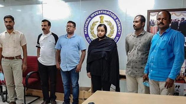 Kerala gold smuggling case accused Swapna Suresh and Sandeep Nair (both in middle) were arrested by the National Investigation Agency in Bengaluru earlier this year for their involvement in the smuggling racket.(PTI PHOTO.)