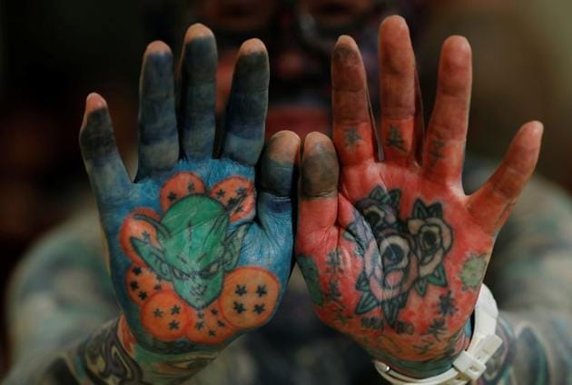 Author Hiroki Takamura, 62, shows tattoos on his palms at the annual gathering of the Irezumi Aikokai (Tattoo Lovers Association) in Tokyo, Japan, February 16, 2020. "In the 2000s, tattoo magazines began to increase and even women began to get more tattoos. I thought there was hope that tattoos would finally be accepted the way they are in Europe", said Takamura. (REUTERS)