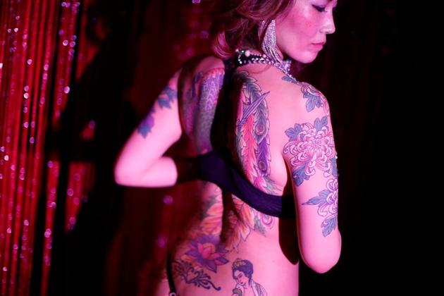 Burlesque dancer Aya Yumiko, 40, who performs under the stage name 'Aya Mermaid' poses with her tattoos at a bar she performs at in Tokyo, Japan, April 25, 2020. "Customers who see me dance with my tattoos, they're really clearly divided between those who like them and those who hate them", said Yumiko. (REUTERS)