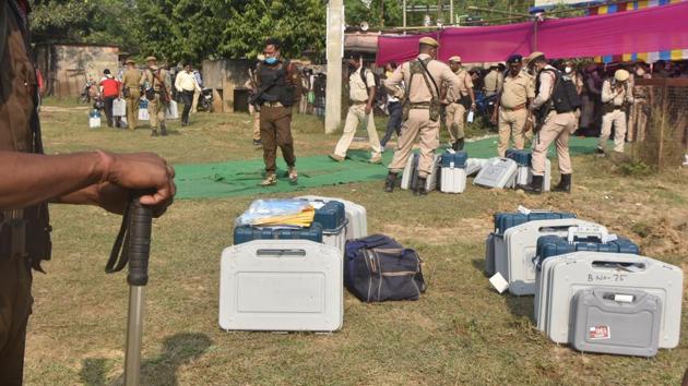 Security personnel seen with EVMs on the eve of the first phase of Bihar Assembly elections at Bharatpura near Patna on October 27. Election commission officials said around 1,200 companies of troops were deployed for security and have notified strict guidelines for distancing, mask-wearing and temperature checks, and procured thousands of personal protective equipment (PPE) and Covid gear, HT reported. (Parwaz Khan / HT Photo)