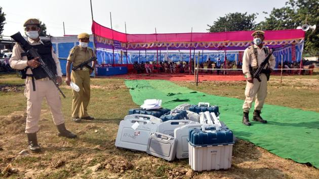 Security personnel stand guard next to EVMs on the eve of the first phase of Bihar Assembly elections in Bharatpura near Patna on October 27. Polling for the second phase will take place on November 3 and the third phase on November 7. The counting of votes will be done on November 10. (Parwaz Khan / HT Photo)