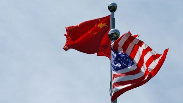 Chinese and US flags flutter near The Bund, before US trade delegation meet their Chinese counterparts for talks in Shanghai, China.(REUTERS)