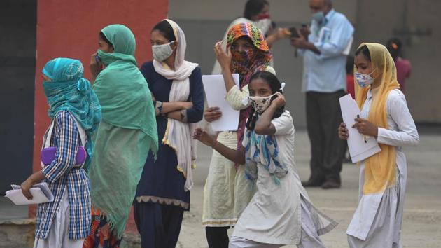 School students coming out of their school after getting worksheets as schools in Delhi are closed due to Covid-19 pandemic in in New Delhi on October 28, 2020.(Sanchit Khanna/HT PHOTO)