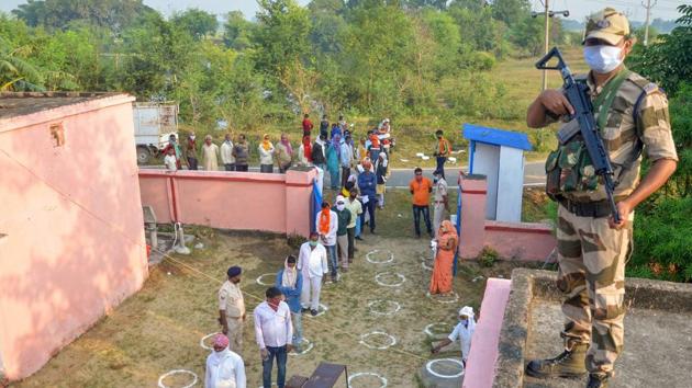 Voters, adhering to social distancing norms, stand in a queue to cast their votes for the Bihar Assembly elections at Alipur block in Kaimur district on October 28. In the first phase of polling, roughly 24.5 million voters will decide the fate of 1,066 candidates--including eight sitting ministers, HT reported. (PTI)