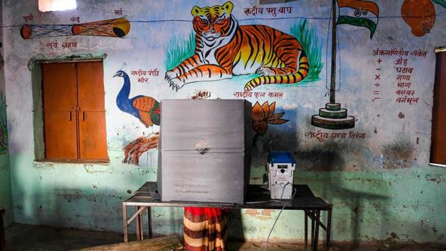 A woman casts her ballot for Bihar Assembly elections at a polling station in Patna on October 28. Bihar is witnessing a triangular contest with the ruling JDU-BJP alliance and grand alliance (RJD, Congress, CPI-ML, CPI, CPIM and others) and Chirag Paswan’s Lok Janshakti Party (LJP), which is eying the role of a kingmaker in case of a hung Assembly. (Prakash Singh / AFP)