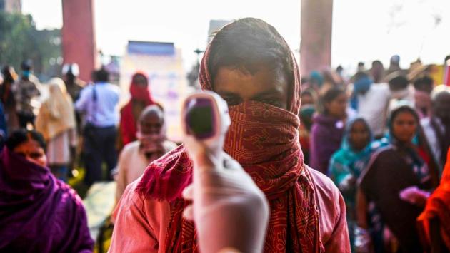 A man undergoes thermal screening before casting his vote at a polling station in Patna on October 28. In the early hours, the turnout was comparatively low till 11am. Patna with 5.96 per cent along with Bhagalpur with 6.84 per cent has recorded the lowest voter turnout. (Sachin Kumar / AFP)