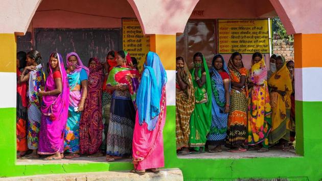 Women queue to cast their votes during the first phase of Bihar Assembly elections in Masaurhi on October 28. According to the Election Commission of India, voter turnout was recorded at 52.24 per cent till 5 pm. Lakhisarai and Nawada districts recorded the highest voter turnout at 26.28 per cent and 23.87 per cent respectively until 11 am. (Prakash Singh / AFP)