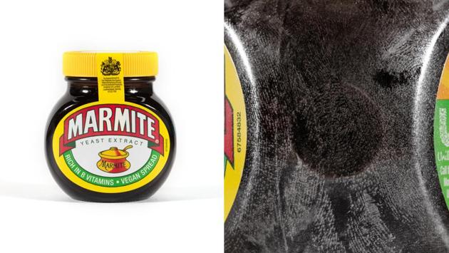 A bottle of Marmite with the fingerprints (on the right) that lie exposed in the photograph. “What began as an inquiry into fears about contamination has also become one about the traces left behind by the labourers who make our modern economies possible,” said Bush, of his work “Latent Labour.” (Lewis Bush)