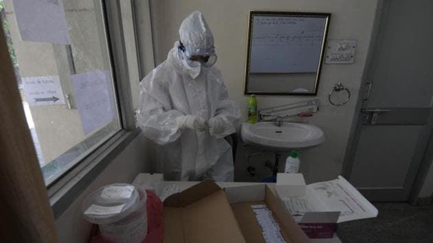 A health worker preserves a swab sample to test for coronavirus infection at Sector 49 in Chandigarh.(Ravi Kumar/HT Photo)