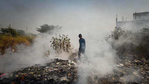 Smoke rises from a smouldering fire due to garbage being burned at Bhalswa in New Delhi on October 27. Delhi is fighting severe air-pollution along with a surge in daily Covid-19 cases. 5,739 new cases were reported on October 29, the highest Delhi has seen until now. (Sanchit Khanna / HT Photo)