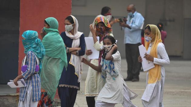 School students coming out of their school after receiving worksheets as schools in Delhi are closed due to Covid-19 pandemic, at Khajuri Khas, in New Delhi.(Sanchit Khanna/HT Photo) School students coming out of their school after receiving worksheets as schools in Delhi are closed due to Covid-19 pandemic, at Khajuri Khas, in New Delhi.(Sanchit Khanna/HT Photo)