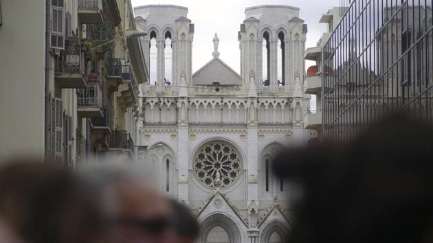 People and journalist stand near the scene of the knife attack at the Notre Dame church, in Nice, France, Thursday, Oct. 29, 2020. An attacker armed with a knife killed three people at a church in the Mediterranean city of Nice, the third attack in two months in France.(AP)