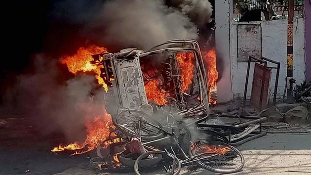 A vehicle set afire by an angry mob during a protest over the recent police firing during a Durga Puja event in Munger, Bihar, on Thursday.(PTI) A vehicle set afire by an angry mob during a protest over the recent police firing during a Durga Puja event in Munger, Bihar, on Thursday.(PTI)