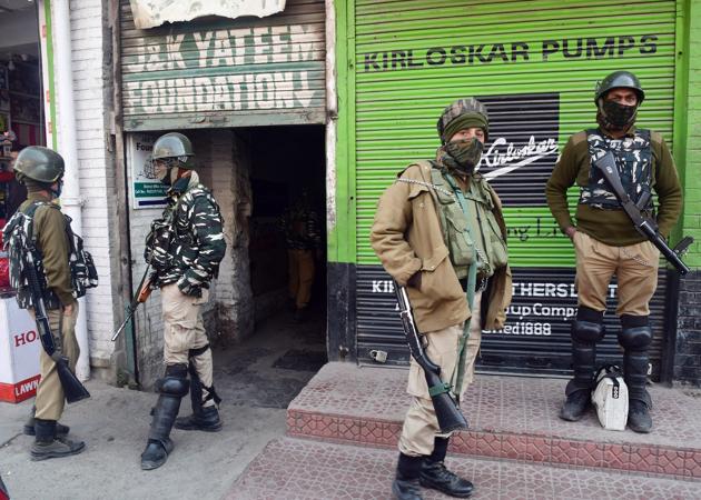 Security personnel standing guard as members of the National Investigation Agency carry out a raid at an office in Srinagar on Thursday. (ANI) Security personnel standing guard as members of the National Investigation Agency carry out a raid at an office in Srinagar on Thursday. (ANI)