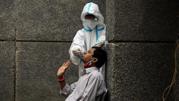 A man grimaces as a health worker collects a swab sample to test for Covid-19, in New Delhi on October 29. The situation in the capital New Delhi also appears on an upswing with 5,673 new cases on October 28, its highest daily figure since the outbreak of the pandemic. Officials have warned that the city could see more than 10,000 cases a day in the next wave, AFP reports. (Anushree Fadnavis / REUTERS)