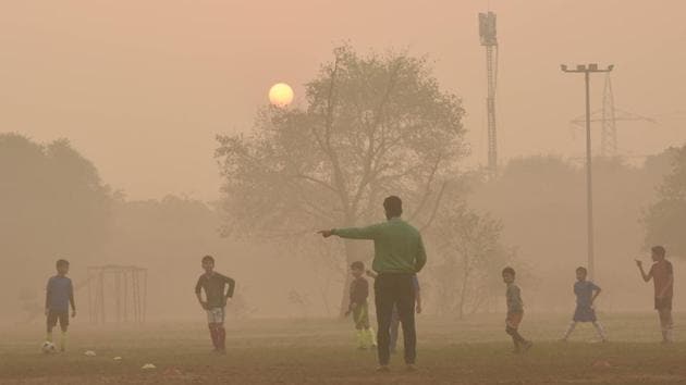 A man instructs children during a football training session on a hazy morning in New Delhi on October 29. Delhi’s air quality was at its worst this season on October 29 as winds heavy with toxic smoke lingered low over the city, Reuters reported. (Vipin Kumar / HT Photo)
