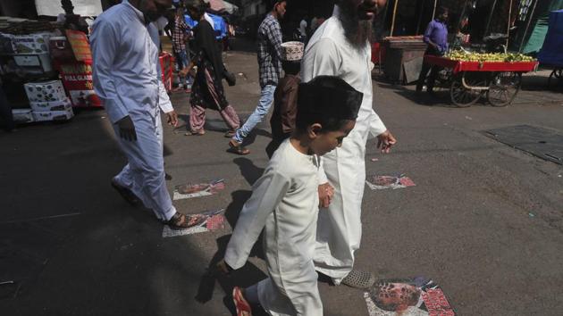 Protesters walk on defaced images of French President Emmanuel Macron pasted on a street in Mumbai, India. (AP) Protesters walk on defaced images of French President Emmanuel Macron pasted on a street in Mumbai, India. (AP)
