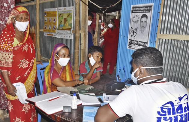 In this photo provided by Bidyanondo Foundation, a doctor writes a prescription for a patient after arriving at Banishanta village near Mongla seaport in southwestern region of Bangladesh, Sept. 1, 2020. (AP)