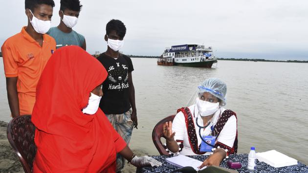 In this photo provided by Bidyanondo Foundation, a doctor examines a patient after arriving at Banishanta village near Mongla seaport in southwestern region of Bangladesh, on Sept. 1, 2020. (AP)