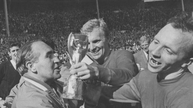 FILE - In this July 30, 1966 file photo, England midfield player Nobby Stiles, right, looks at the Jules Rimet Cup, held by England captain Bobby Moore after they had won the World Cup Final at Wembley, London.(AP)