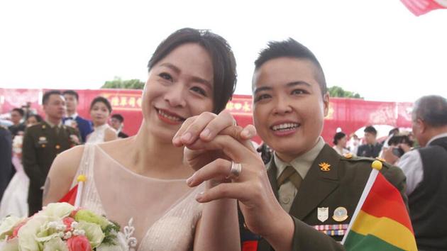 Lesbian couple Yi Wang, right, and Yumi Meng show their wedding rings during a military mass weddings ceremony in Taoyuan city, northern Taiwan.(Associated Press) Lesbian couple Yi Wang, right, and Yumi Meng show their wedding rings during a military mass weddings ceremony in Taoyuan city, northern Taiwan.(Associated Press)