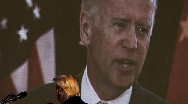 Democratic US presidential nominee and former Vice President Joe Biden is seen on a screen as US President Donald Trump watches a campaign add during his campaign rally at Green Bay Austin Straubel International Airport in Green Bay, Wisconsin.(REUTERS) Democratic US presidential nominee and former Vice President Joe Biden is seen on a screen as US President Donald Trump watches a campaign add during his campaign rally at Green Bay Austin Straubel International Airport in Green Bay, Wisconsin.(REUTERS)