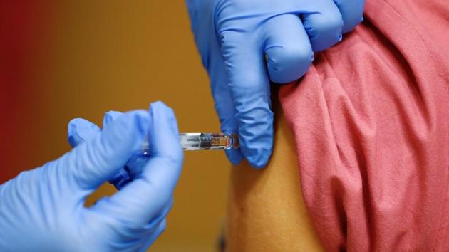 A member of the medical staff receives a flu vaccine at the department where patients suffering from the coronavirus disease (Covid-19) are treated in the Intensive Care Unit (ICU) at Havelhoehe community hospital in Berlin.(Reuters File Photo) A member of the medical staff receives a flu vaccine at the department where patients suffering from the coronavirus disease (Covid-19) are treated in the Intensive Care Unit (ICU) at Havelhoehe community hospital in Berlin.(Reuters File Photo)