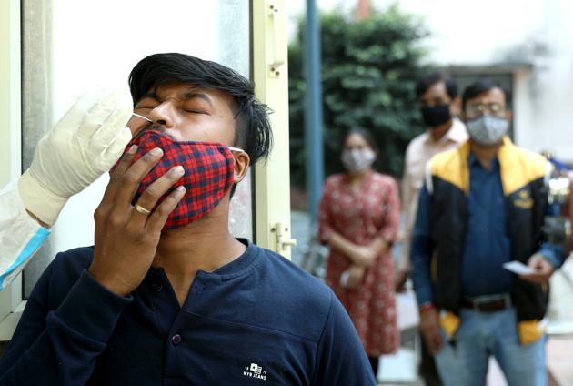 A health worker collects a nasal sample from a man at a health centre.(ANI) A health worker collects a nasal sample from a man at a health centre.(ANI)