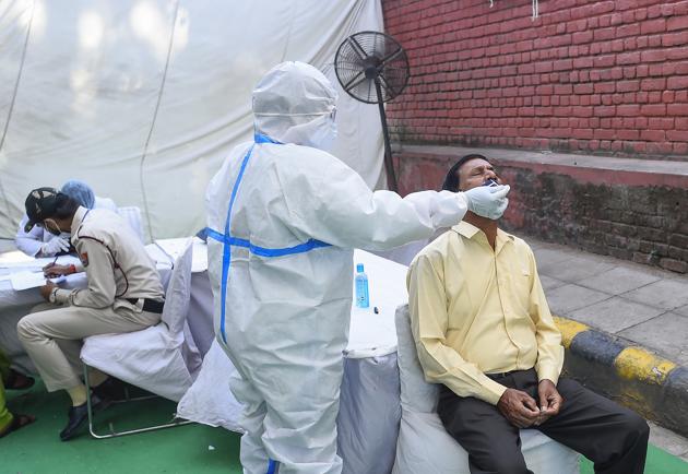A health worker collects swab samples for Covid- 19 tests.(PTI) A health worker collects swab samples for Covid- 19 tests.(PTI)