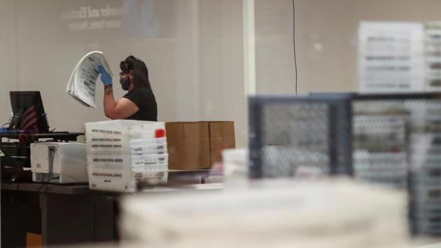 A woman works at the Maricopa County Elections ballot processing center in Phoenix, Arizona US on October 30, 2020.(Reuters Photo) A woman works at the Maricopa County Elections ballot processing center in Phoenix, Arizona US on October 30, 2020.(Reuters Photo)