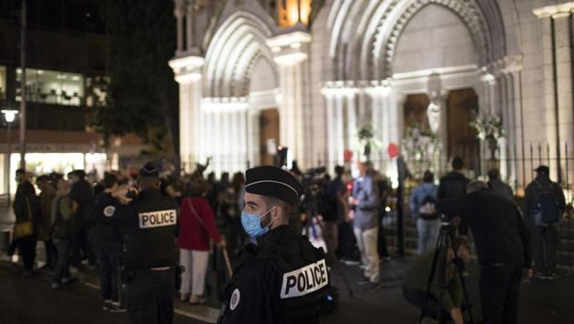 A policeman stands guard in front of the Notre Dame church in Nice, France on Friday.(AP Photo) A policeman stands guard in front of the Notre Dame church in Nice, France on Friday.(AP Photo)