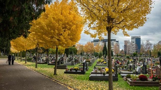 A couple walks in a cemetery in Strasbourg on October 30. President Emmanuel Macron has warned that the second wave “will probably be more difficult and deadly than the first” in a country that has already seen 36,000 deaths from Covid-19. (Patrick Hertzog / AFP)