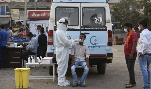 A health worker collects a swab sample for coronavirus test at Khandsa road, in Gurugram.(Praveen Kumar/HT) A health worker collects a swab sample for coronavirus test at Khandsa road, in Gurugram.(Praveen Kumar/HT)