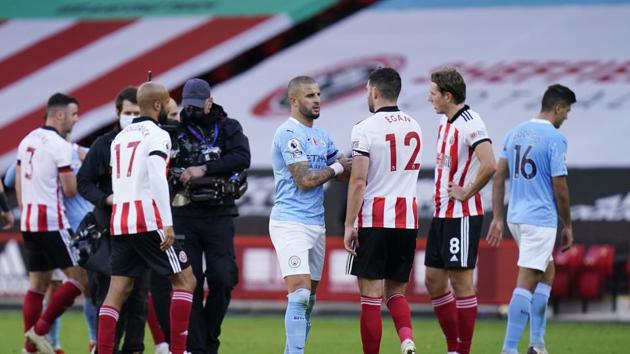 Manchester City's Kyle Walker with Sheffield United's John Egan after the match Pool via REUTERS/Tim Keeton EDITORIAL USE ONLY. No use with unauthorized audio, video, data, fixture lists, club/league logos or 'live' services. Online in-match use limited to 75 images, no video emulation. No use in betting, games or single club /league/player publications. Please contact your account representative for further details.(Pool via REUTERS) Manchester City's Kyle Walker with Sheffield United's John Egan after the match Pool via REUTERS/Tim Keeton EDITORIAL USE ONLY. No use with unauthorized audio, video, data, fixture lists, club/league logos or 'live' services. Online in-match use limited to 75 images, no video emulation. No use in betting, games or single club /league/player publications. Please contact your account representative for further details.(Pool via REUTERS)