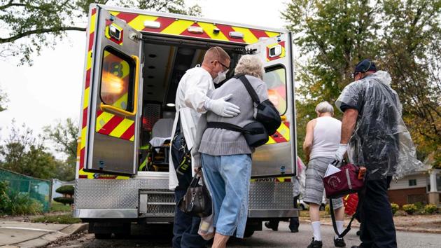 Firefighters and paramedics with Anne Arundel County Fire Department assist confirmed Covid-19 positive patients in Glen Burnie, Maryland on October 26. (Alex Edelman / AFP) Firefighters and paramedics with Anne Arundel County Fire Department assist confirmed Covid-19 positive patients in Glen Burnie, Maryland on October 26. (Alex Edelman / AFP)